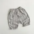 Detail of children's striped linen shorts featuring elastic waist and folded cuffs - White Striped / 80cm
