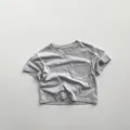 Detail shot of a minimalist grey cotton kids T-shirt featuring a small square chest pocket - Light Gray