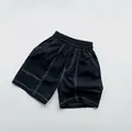 Detailed close-up of dark blue cotton kids' shorts featuring white contrast stitching - 80 / Black