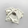 T-shirt enfant en coton crème posé à plat avec imprimé Cheese rétro et col rond - Abricot Beige / 80cm