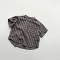 Detail of grey striped kids short sleeve shirt with stand collar and chest pocket - Gray Stripe / 120cm