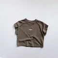 Detail view of cotton T-shirt neckline with HOPE text print in dark coffee color - 80cm / Brown
