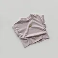 Close-up of lilac cotton t-shirt featuring rolled cuffs and ice cream summer chest patch - 80cm / Gray Purple