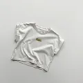 Detail of light gray cotton kids T-shirt featuring a small ICE CREAM woven chest label - 80cm / Apricot