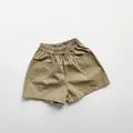 Detail of khaki cotton kids shorts featuring elastic waistband and functional side pockets - 80cm / Khaki