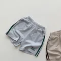 Detail of kids knit cotton shorts featuring elastic waist and side contrast stripes - 80cm / Light Gray