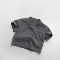 Close-up of lightweight dark grey cotton shirt with Café No.27 print on chest - Dark Gray / 80cm