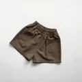 Detailed macro view of elastic waistband and pockets on Morandi style kids cotton shorts - 80cm / Sand Brown
