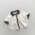 Detailopname van kinderoverhemd van katoen en linnen met kleurblokken en contrast - 80cm / Beige Abrikoos
