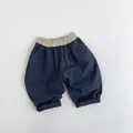 Detail of navy blue kids casual pants with beige elastic waistband and neat stitching - Navy Blue / 80cm