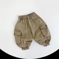 Detail of kids cargo pants showing elastic waistband and large side utility pockets - 80cm / Earthy Yellow