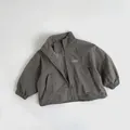 Close-up of gray-green children jacket with G-Sun 7 logo and elastic cuffs detail - 80cm / Grey Coffee