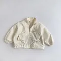 Detail of white children's windbreaker jacket showing zip collar and G-Sun print - 80cm / Beige Apricot