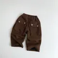 Detail of dark brown kids cargo pants with elastic waist and large side pockets - 80 / Coffee
