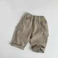 Dettaglio di pantaloni cargo bimbi kaki foderati in pile con vita elastica e tasche - 80cm / Color Tè al Latte