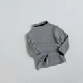 Close-up of kids ribbed knit sweater featuring grey fabric and black contrast trim - 80cm / Light Grey