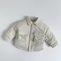 Close-up of beige children's down shirt jacket with flap pockets and button details - 80cm / Apricot