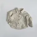 Close-up of beige cotton kids shirt featuring classic collar and letter embroidery detail - 80cm / Beige Apricot