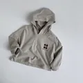 Detail view of khaki cotton hoodie for kids with lucky graphic and side slit hem - 80 / Beige Grey