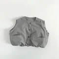 Detailed view of gray kids vest featuring four buttons and large front pockets - 80cm / Grey Green