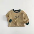 Close-up of kids khaki sweatshirt featuring dark green ribbed neckline and cuffs - 80cm / Wheat Yellow