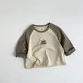 Close-up of kids raglan long sleeve shirt showing soft cotton fabric and print detail - 80cm / Almond Beige