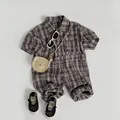 Flat lay of baby brown plaid short sleeve romper with cute bear bag and sunglasses - 80cm / Brown Green Plaid