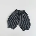 Detailed close-up of grey vertical striped kids trousers with elastic waistband - 80 / Dark Grey Stripes