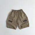 Detail of khaki cargo shorts with elastic waist and large side pockets for boys - Dark Khaki / 80cm