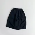 Detail of children's cotton pants showing elastic waistband, button, and breathable fabric - Black / 80cm