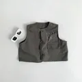 Detail of dark grey kids cotton utility vest with three buttons and HEY graphic print - Dark Gray / 80cm