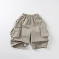 Detail view of khaki cotton cargo shorts for kids with elastic waistband and large side pockets - 80cm / Khaki