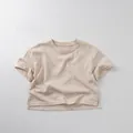 Detail view of beige cotton kids T-shirt showing side slit and minimalist fabric texture - 80cm / Light Apricot