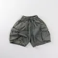 Detail of retro washed denim kids cargo shorts with elastic waist and large side pockets - 80cm / Washed Blue