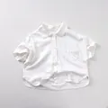 Detailed macro view of white cotton-linen baby shirt with lapel collar and chest pocket - 80cm / White