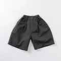Detail of dark grey cotton shorts showing elastic waist with belt loops and side pockets - 80cm / Dark Gray