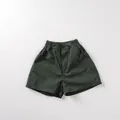 Detail of dark green cotton kids' shorts featuring elastic waist and side pockets - 80 / Dark Green