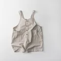 Close-up of neutral-toned cotton linen kids overalls with button detail and side pockets - 80cm / Beige Grey