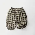 Detailed view of kids breathable cotton pants with black polka dots and elastic cuffs - Khaki / 80cm