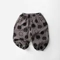 Detail of grey-brown cotton kids pants with black fruit print and elastic waistband - Gray Purple / 80cm