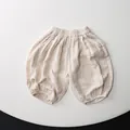 Detailed macro view of cream-colored kids' cotton bloomers with elastic waistband and cuffs - Apricot / 80cm