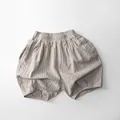Detail of light brown toddler bloomers with elastic waist and vertical striped cotton linen - 80cm / Apricot Stripe