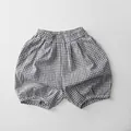 Detail of kids black and white gingham bloomers with elastic waist and soft cotton texture - 80cm / Grey and White Plaid
