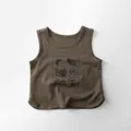 Detailed macro view of children brown cotton vest showing retro forest style prints - 80cm / Tea Brown