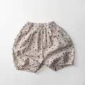 Detail of kids linen bloomers showing elastic waist and embroidered polka dot pattern - 80cm / Apricot Polka Dot