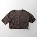 Macro detail of breathable knit fabric and buttons on children brown v-neck cardigan - 80cm / Coffee