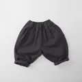 Flat lay of dark grey cotton kids wide-leg trousers with an elastic waist and cuffed hem - 80 / Dark Gray