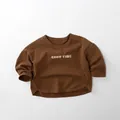 Detail of dark brown cotton kids T-shirt featuring white GOOD TIME letter print and curved hem - 80cm / Caramel color