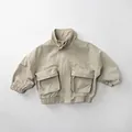 Detailed close-up of beige cotton cargo jacket for kids featuring large utility pockets - Beige / 80cm