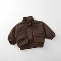 Detail view of dark brown kids utility jacket with stand collar and large cargo pockets - Dark Brown / 80cm